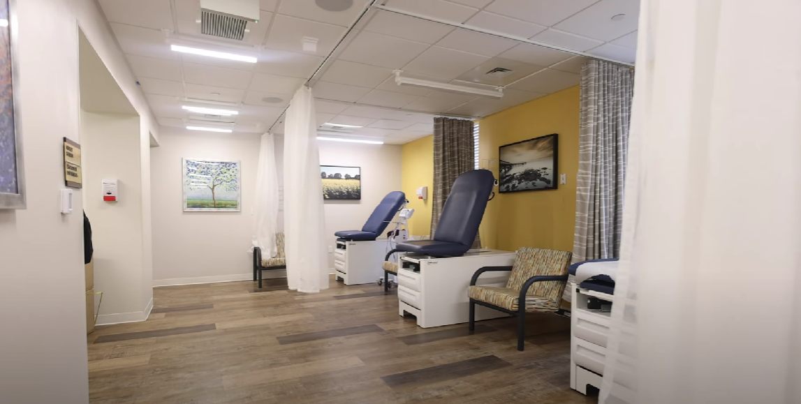 Exam room with medical chairs and privacy curtains