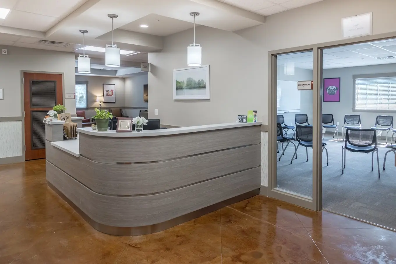 Reception desk with seating area and view into group therapy room