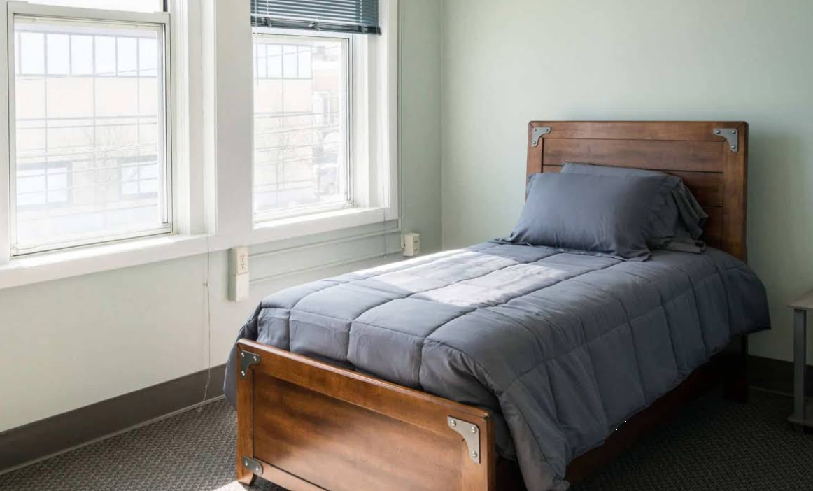 Private bedroom with single bed and large windows