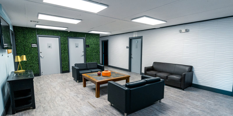 Interior lounge with sofas, a coffee table, and a calm, modern design.