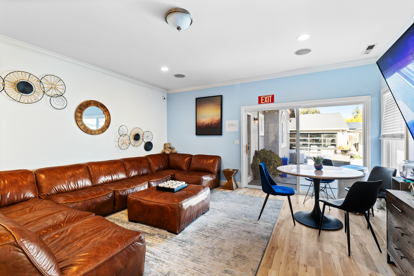 Leather sectional couch with table and wall art
