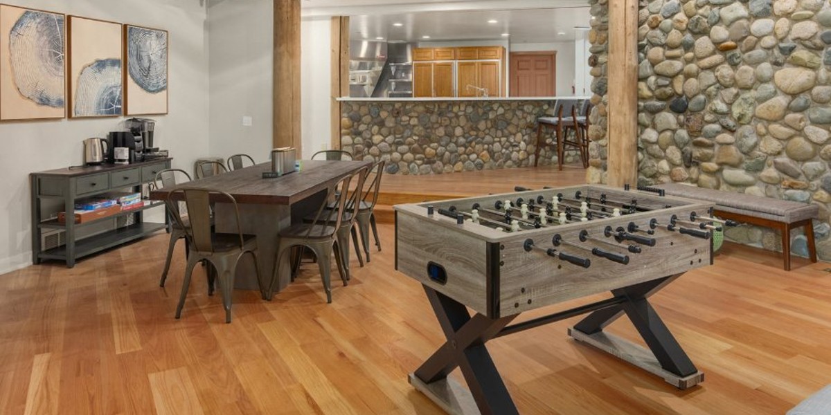 Game and dining room with foosball table and seating