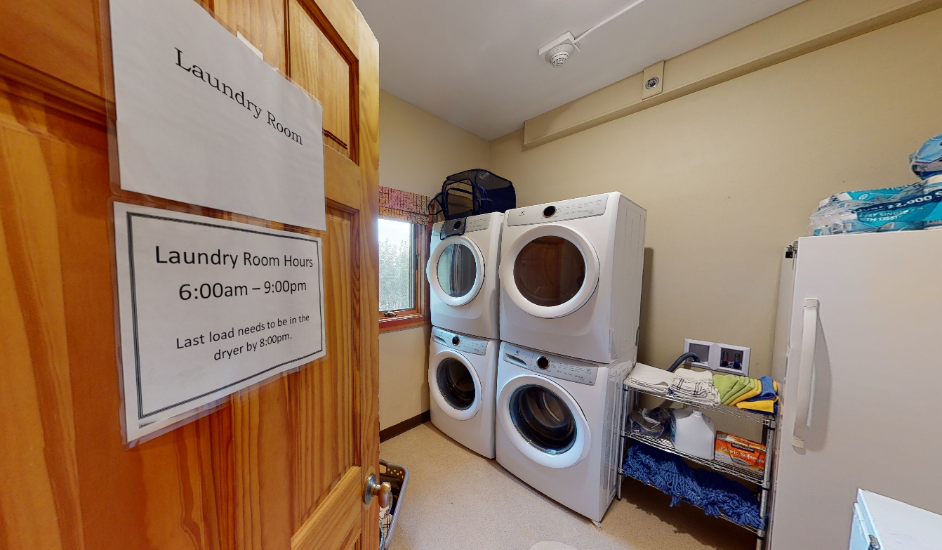 Laundry room with washers, dryers, and folding area