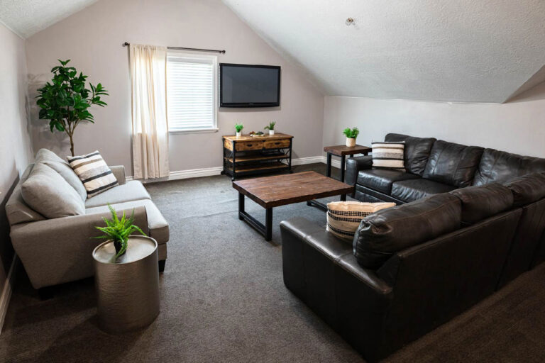 Group therapy lounge with sofas at Ascend Recovery