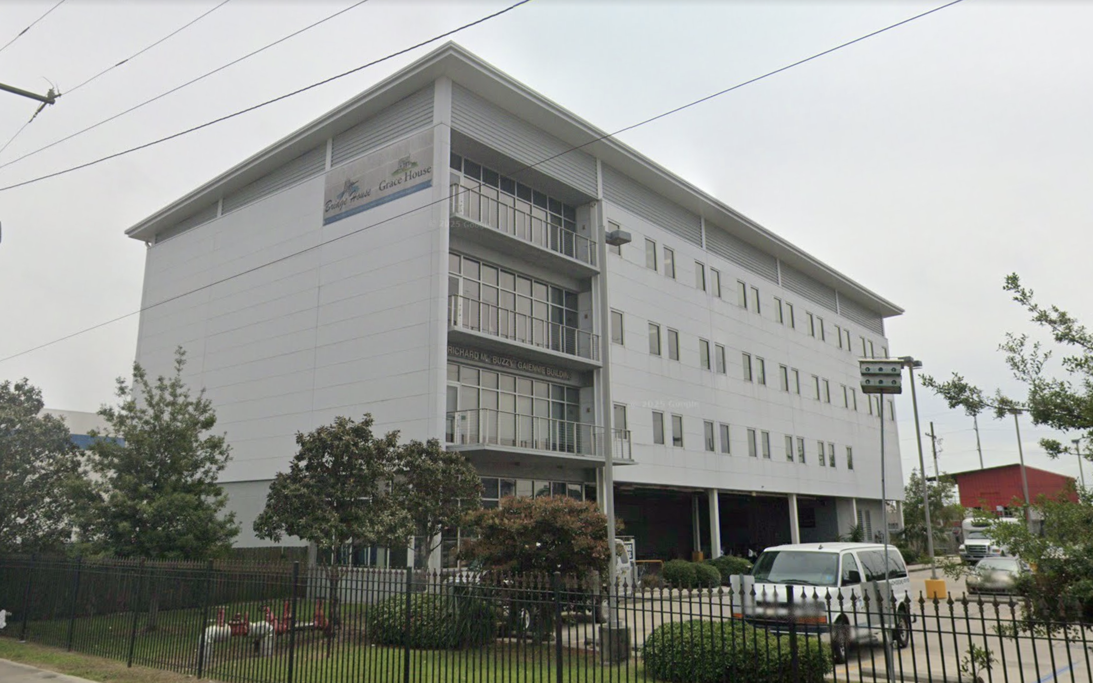 Multi-story Bridge House facility with fenced grounds