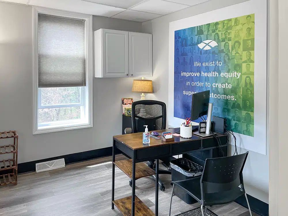 Small office with desk, chair, and wall art