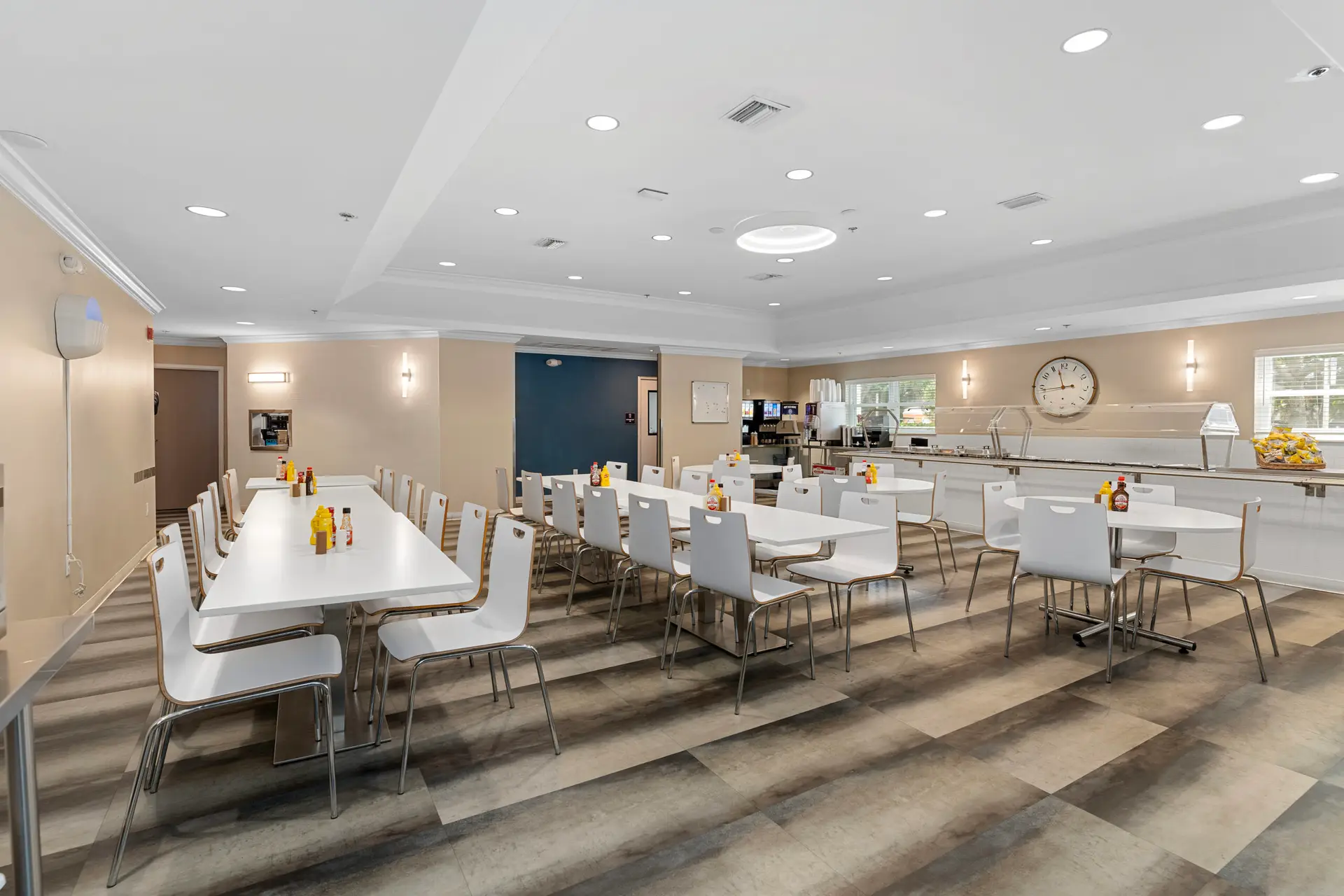 Modern dining room with white chairs and serving line