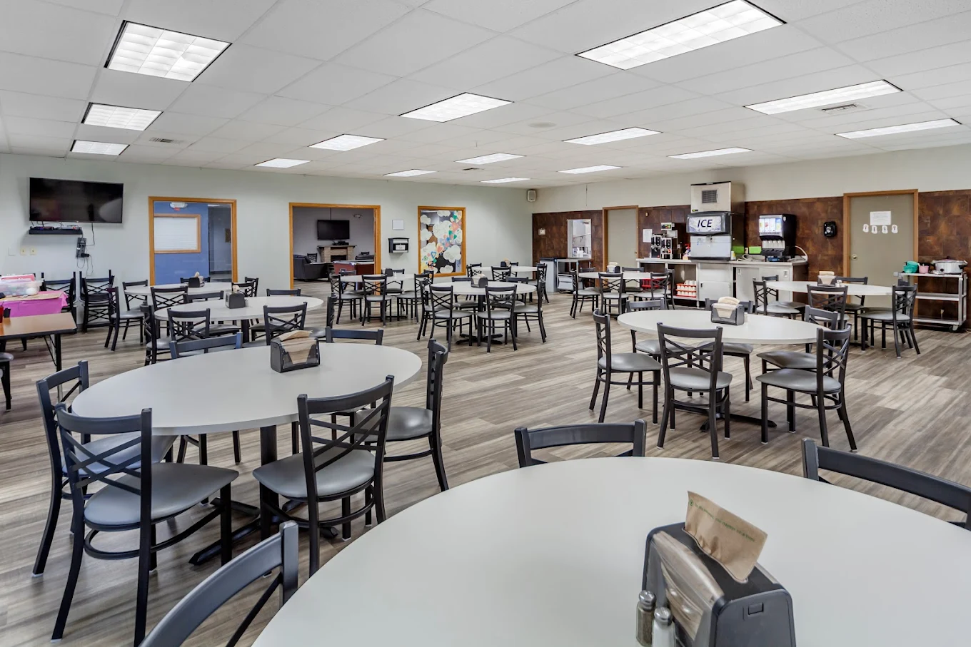 Dining hall with tables and beverage station
