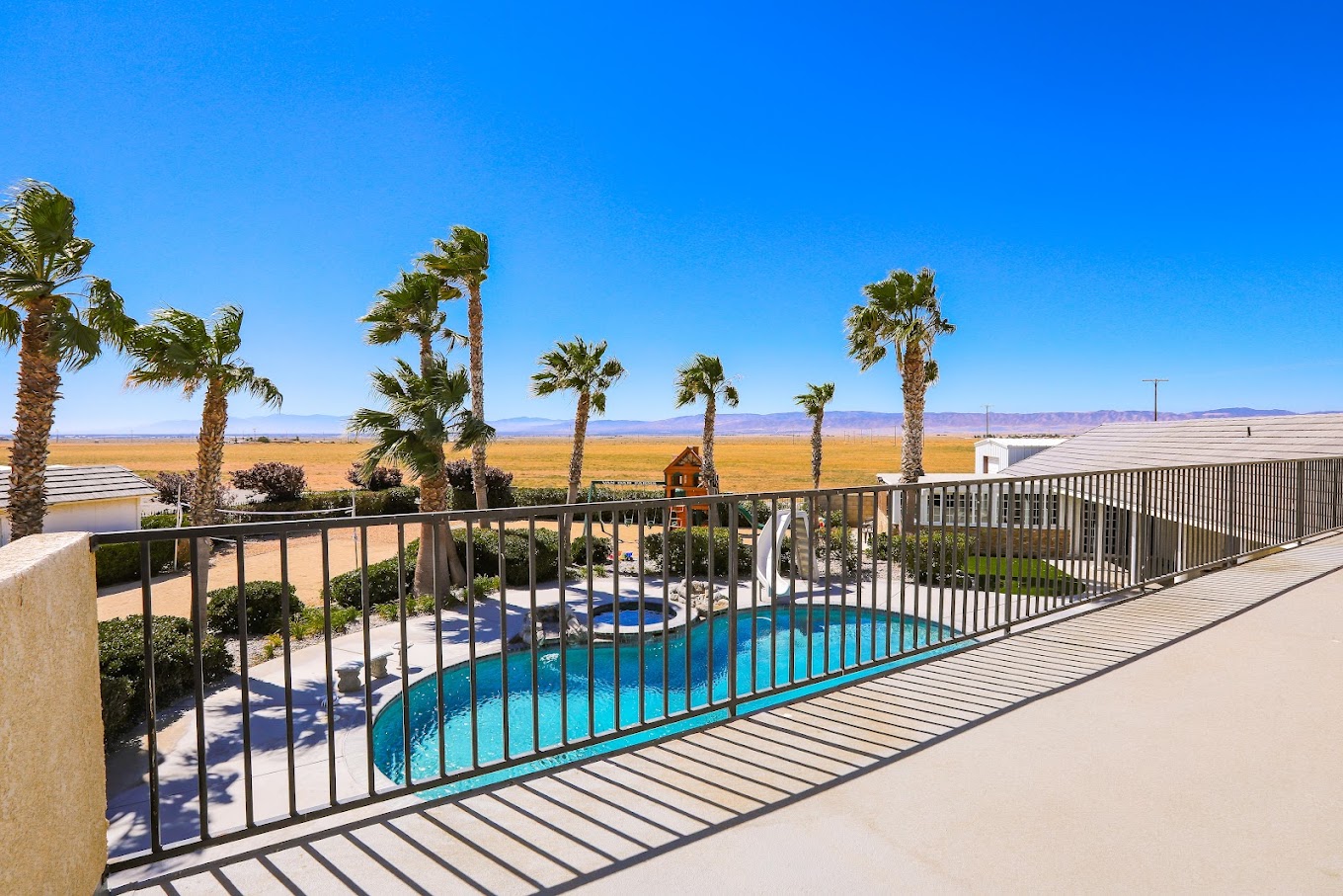 Balcony view of pool and distant mountain landscape