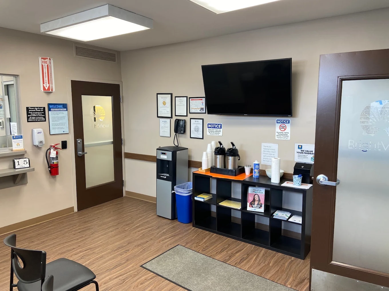 Waiting area with service window, chairs, and water cooler