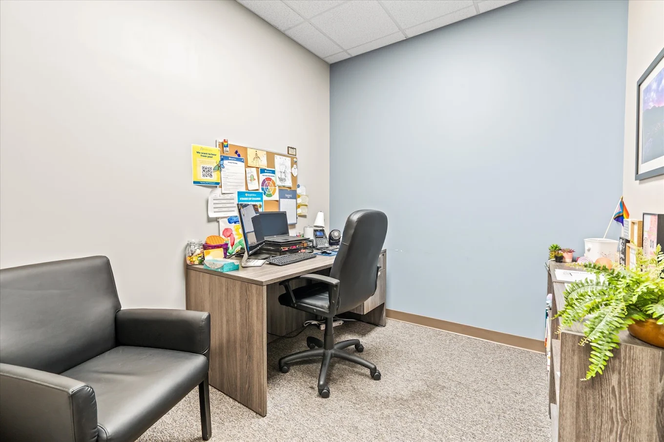 Private consultation room at BrightView Health Dayton with desk, computer workstation, patient chair, bulletin board, and plants