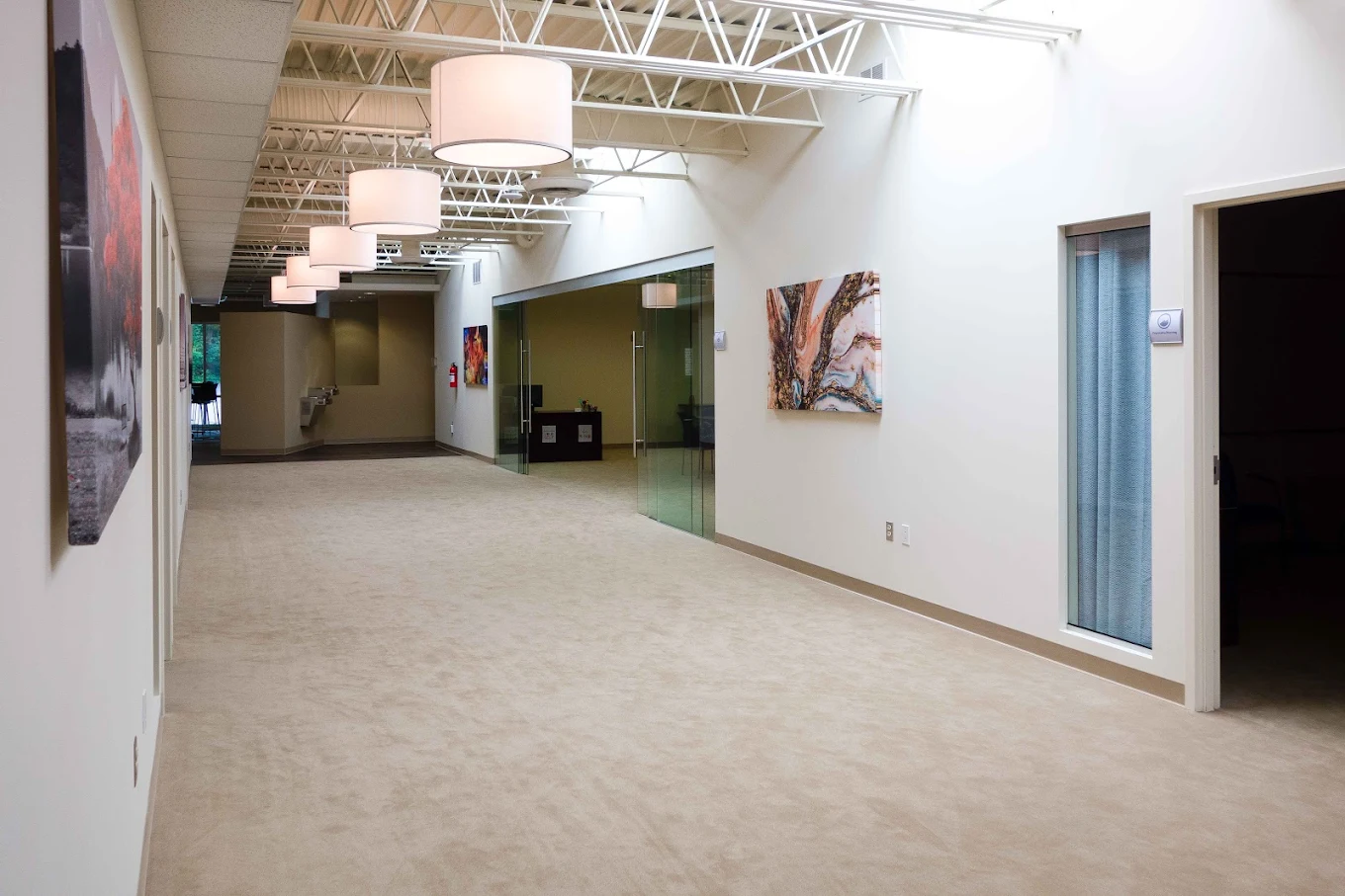Hallway lounge with wall art and carpet flooring