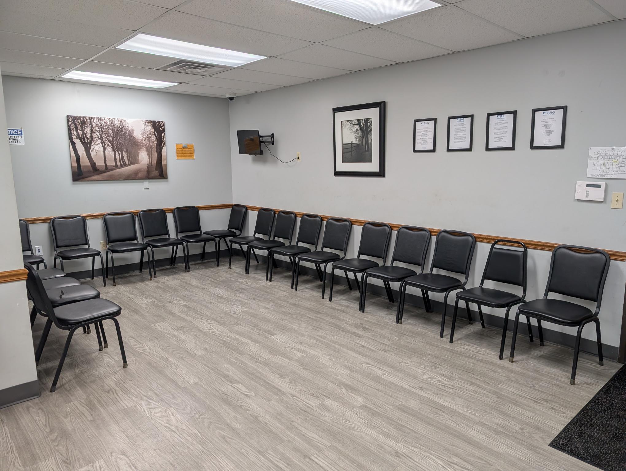 Spacious waiting area with chairs along the walls