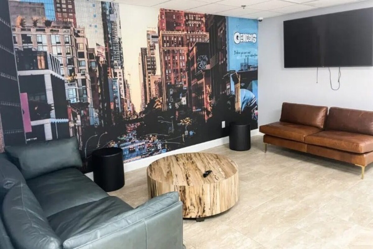 Room with couches and wall mural