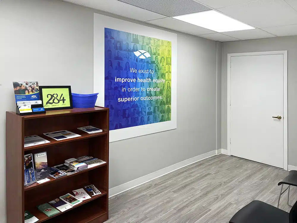 Small area with bookshelf and health equity wall sign