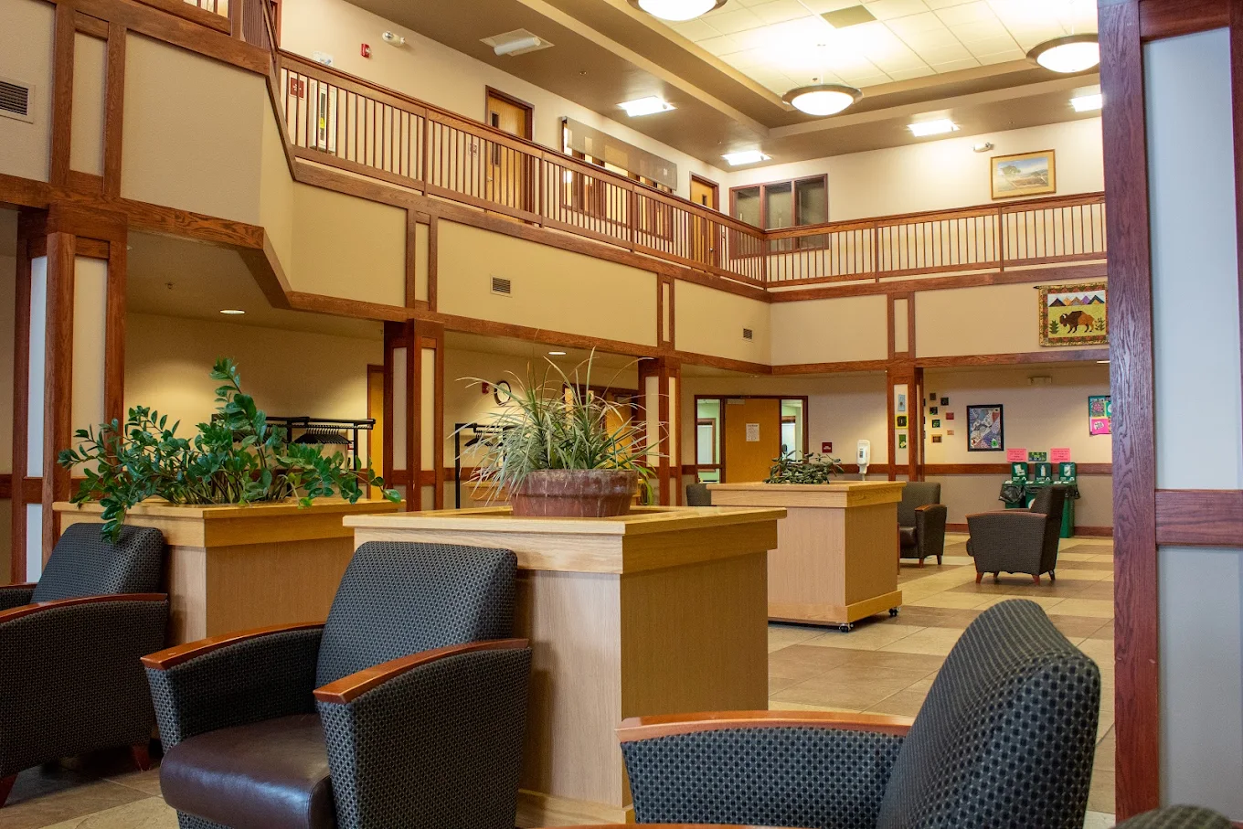 Spacious two-story atrium with seating and indoor plants