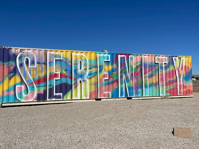 Colorful mural container with large word “Serenity” painted