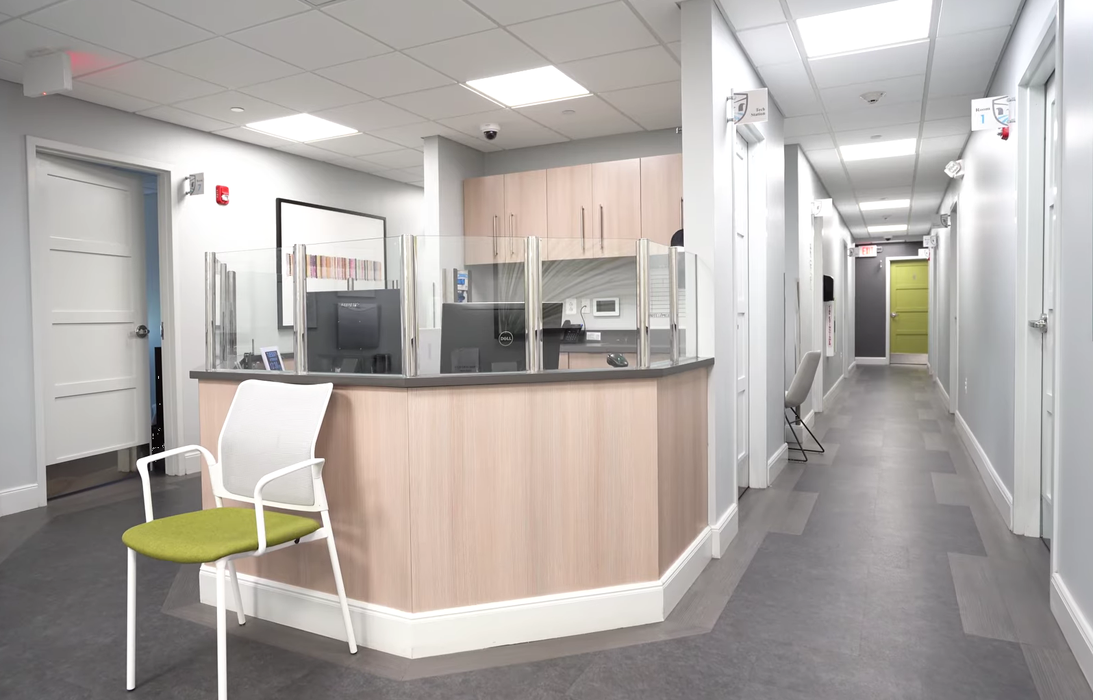 Admissions desk with protective glass and hallway access