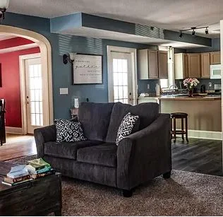 Comfortable shared living room with seating and open kitchen view