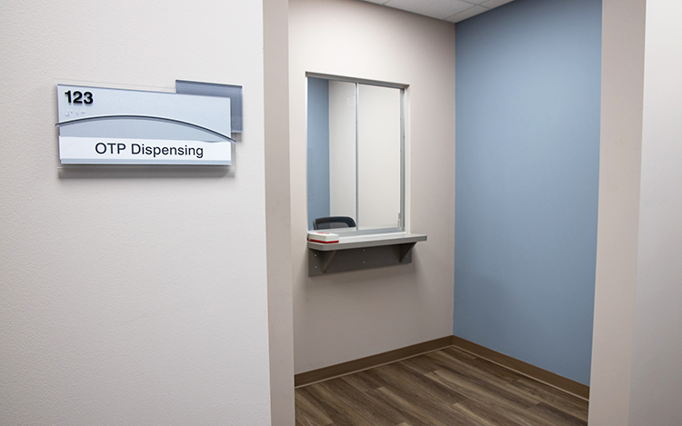 Medication dispensing area with service window and blue wall