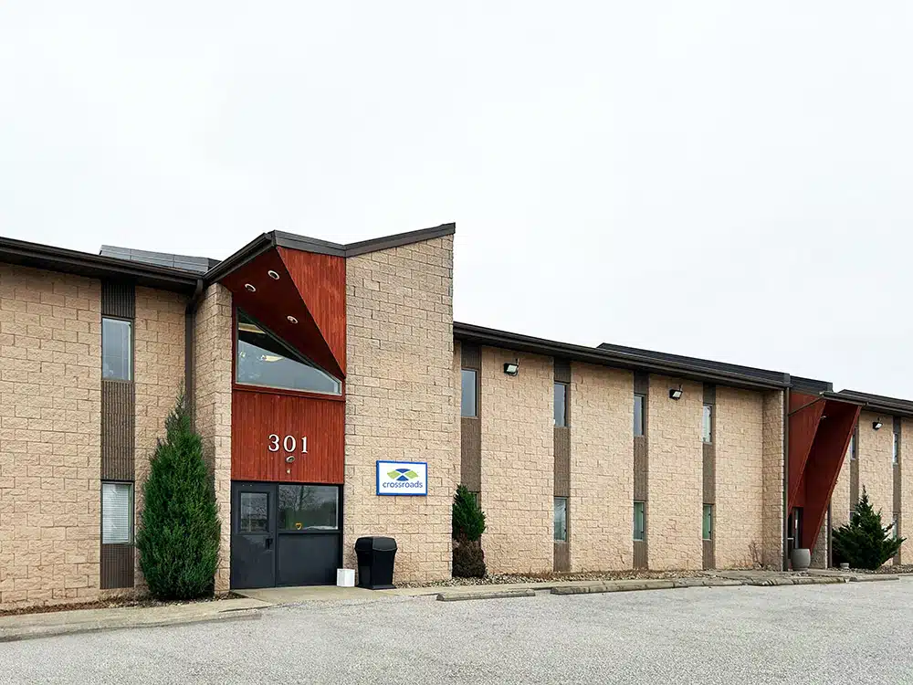 Wide view of tan brick Crossroads treatment center building