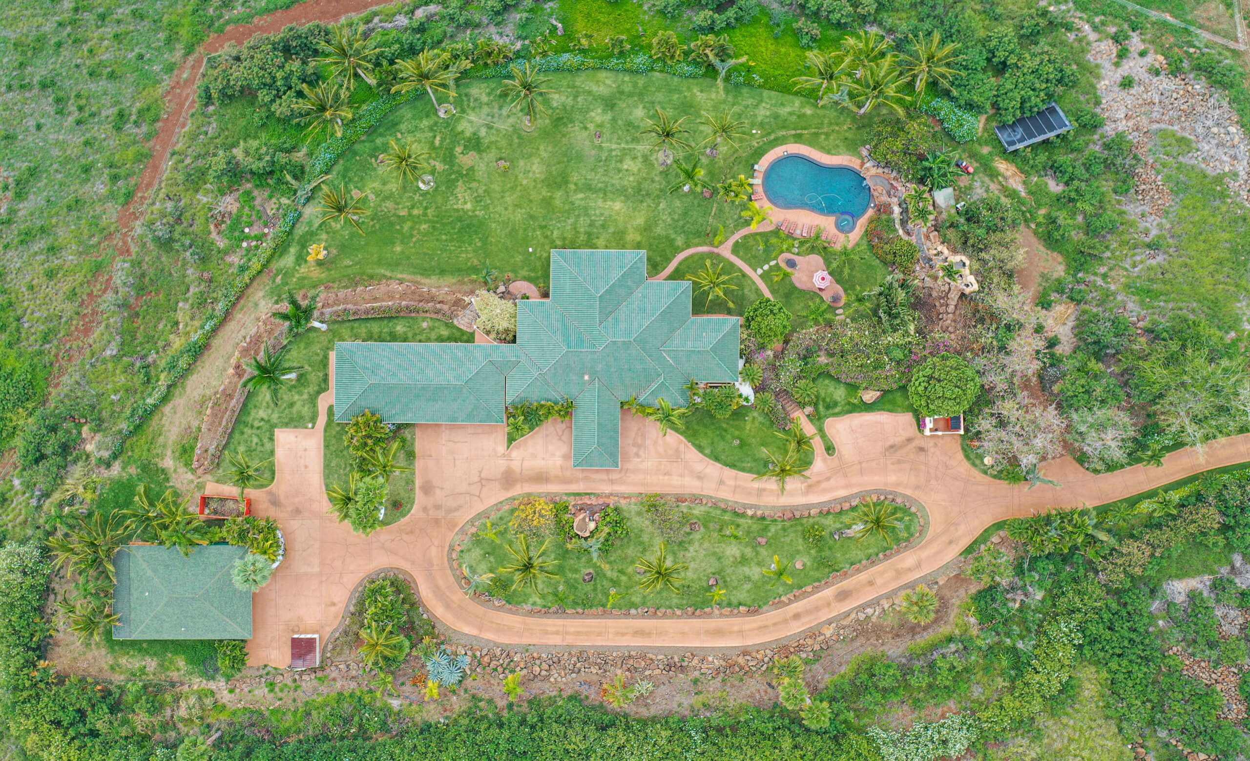 Aerial view of Maui Recovery's private estate with landscaped grounds, pool, and tropical surroundings