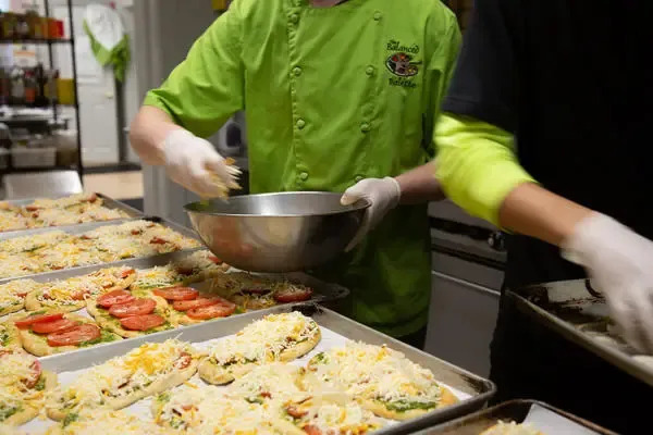 Staff preparing fresh meals in a facility kitchen.