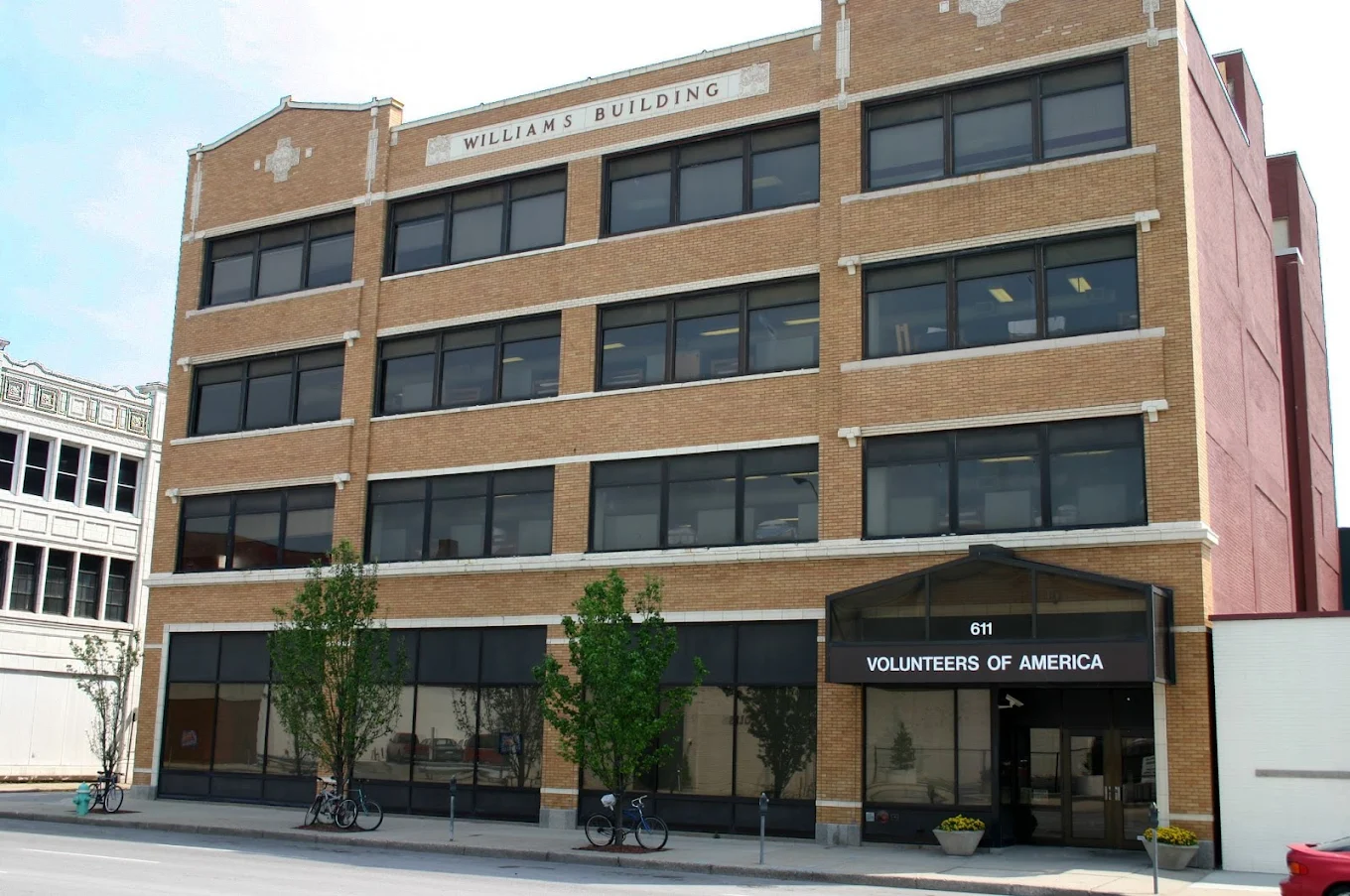 Four-story brick building with Volunteers of America sign at entrance