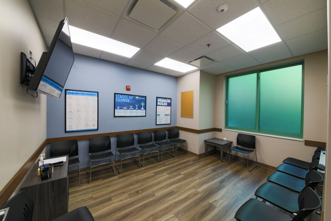 Group therapy room with seating and recovery education posters