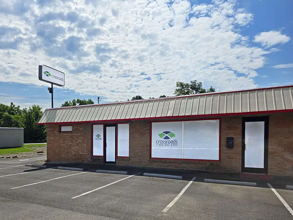 Brick rehab center exterior with parking lot and signage