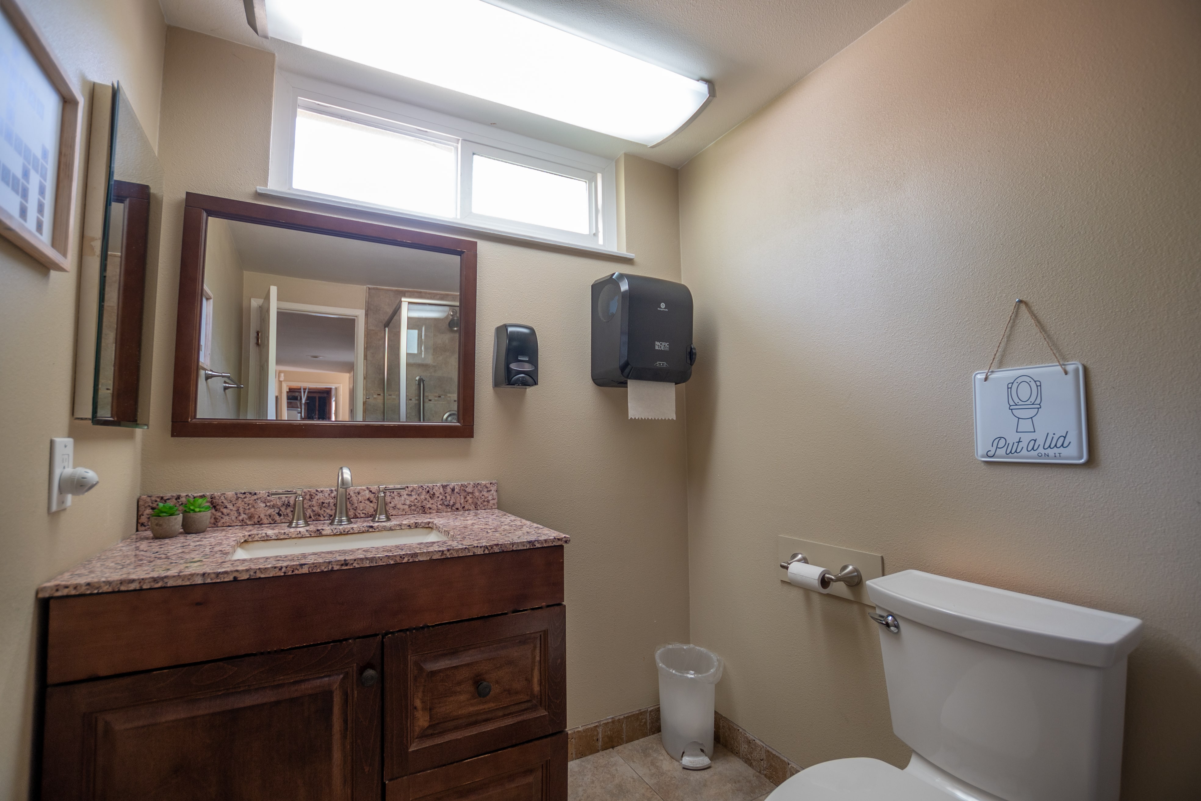Bathroom with granite vanity and mirror