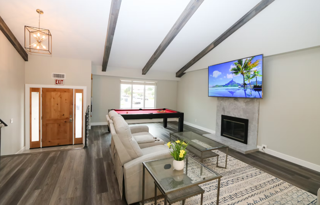 Living room with sectional sofa, TV, and pool table