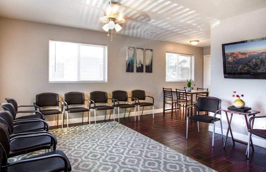 Group therapy room with chairs in circle and wall art