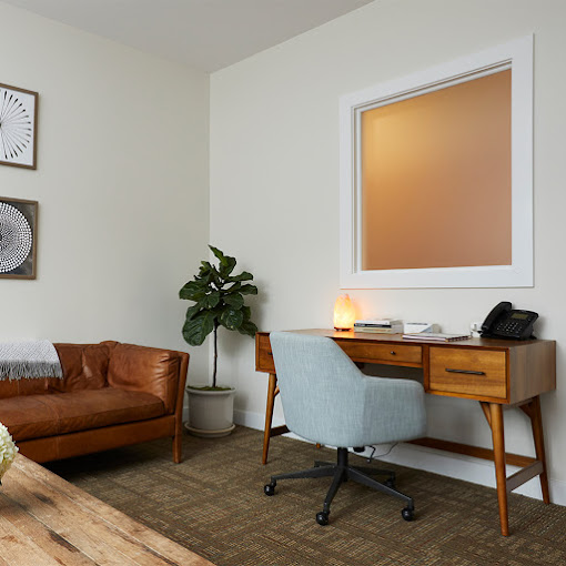 Office space with a desk and a couch.