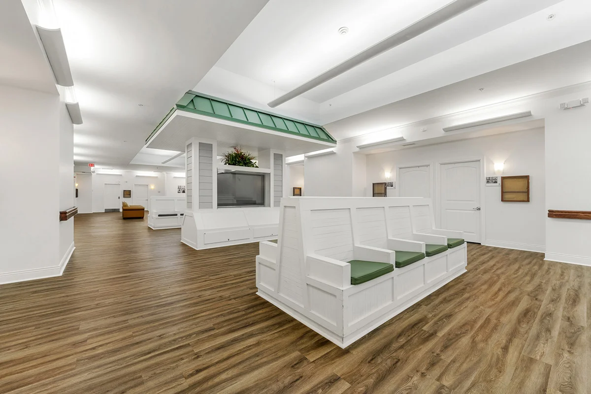 Spacious indoor common area with built-in seating and open gathering space for residents