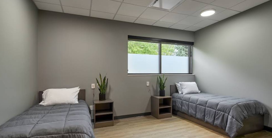 Shared patient room with two beds and bedside tables