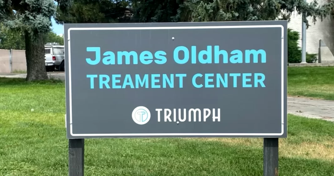 Sign reading “James Oldham Treatment Center, Triumph”