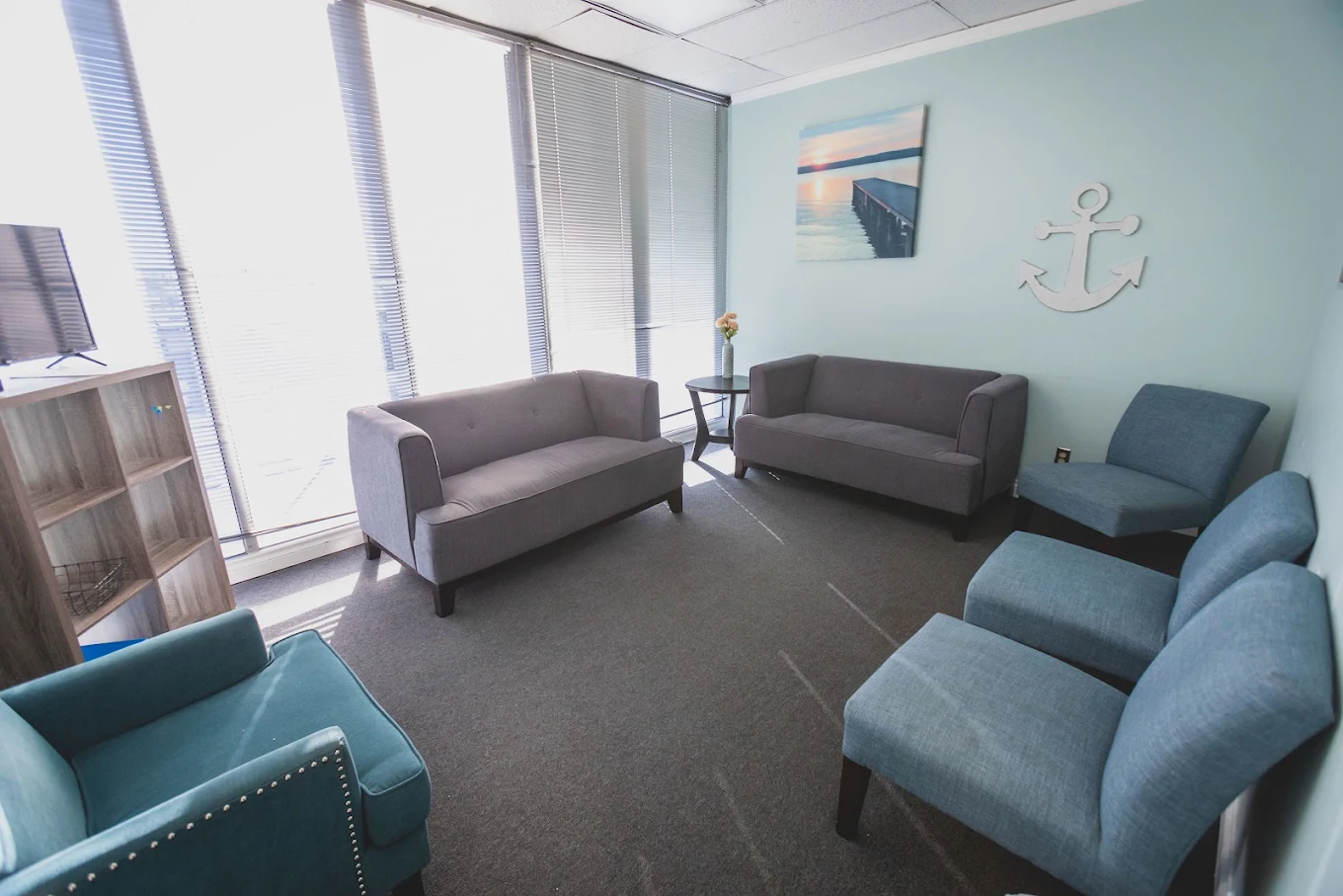 Group therapy room with sofas and chairs arranged for meetings