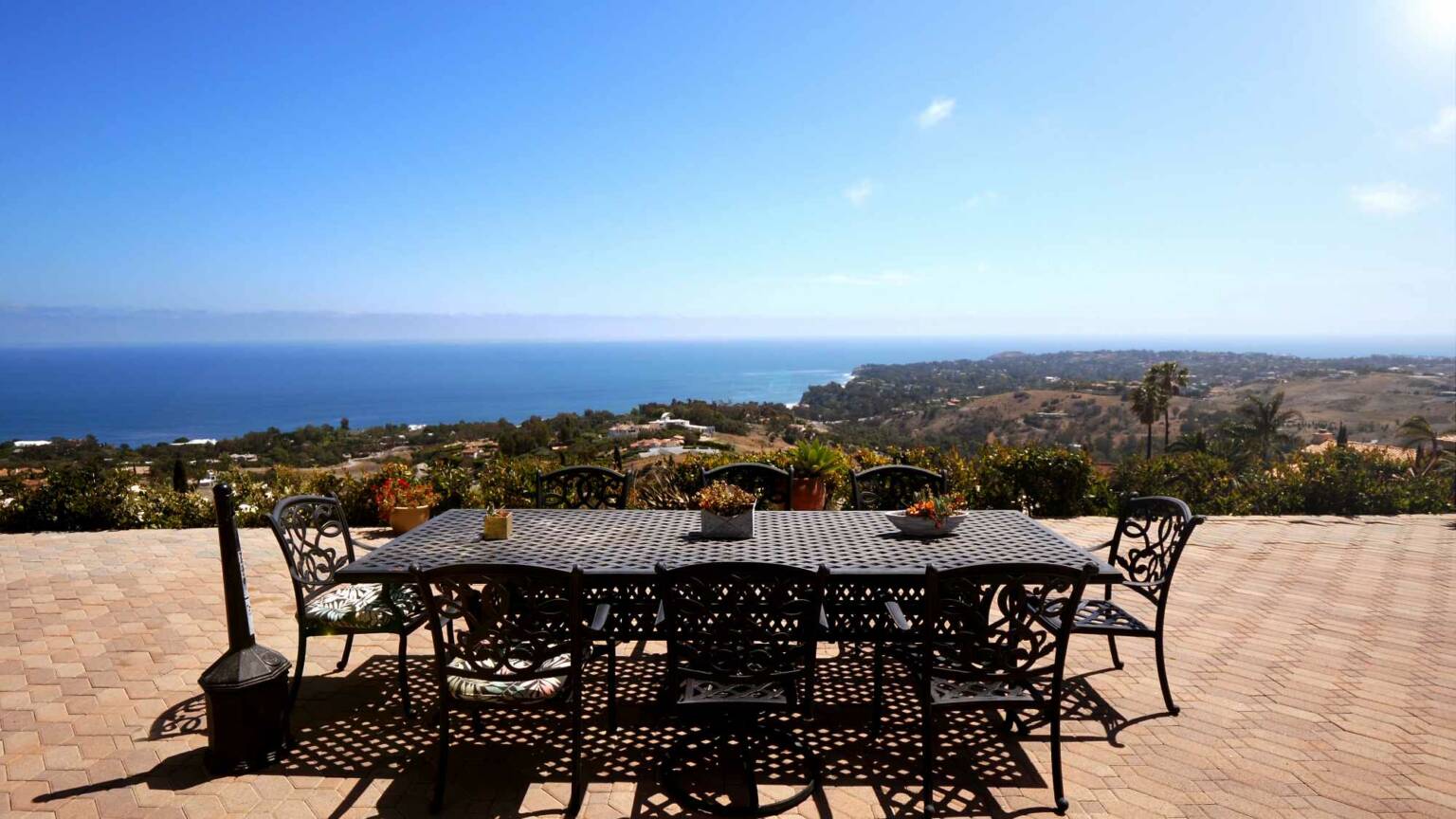 Patio dining table overlooking the ocean and hills