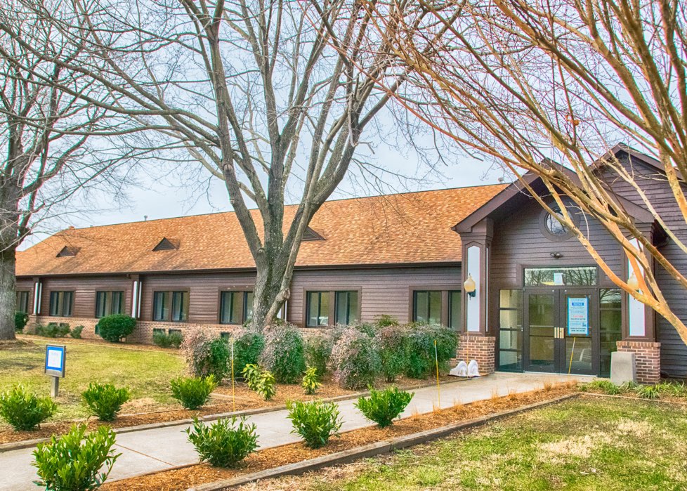 Facility exterior with paved walkway to entrance.