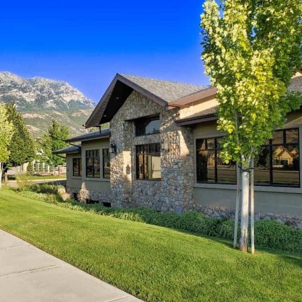 Scenic exterior with mountains and green lawn