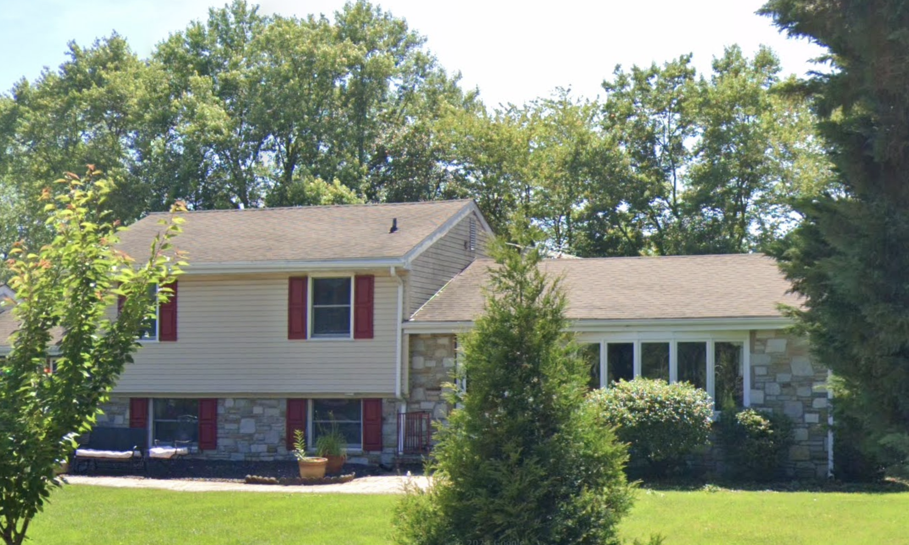 A cozy suburban home with a neatly landscaped front yard, providing a welcoming and comforting atmosphere.