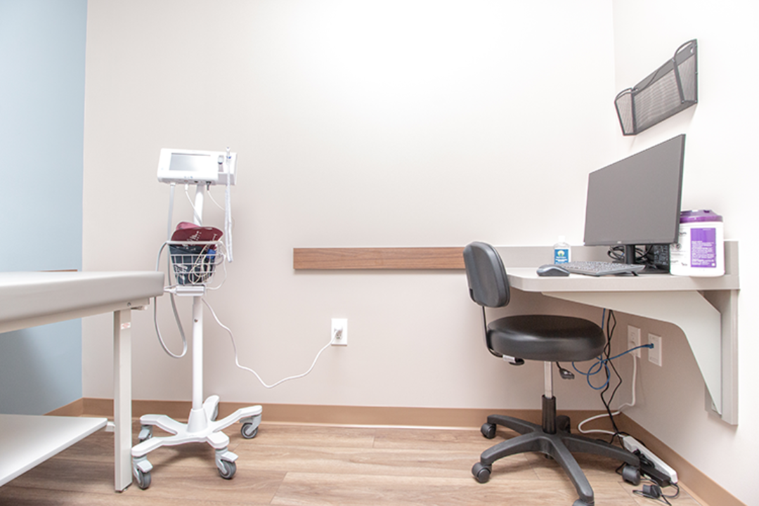 Clinical room with computer and medical equipment