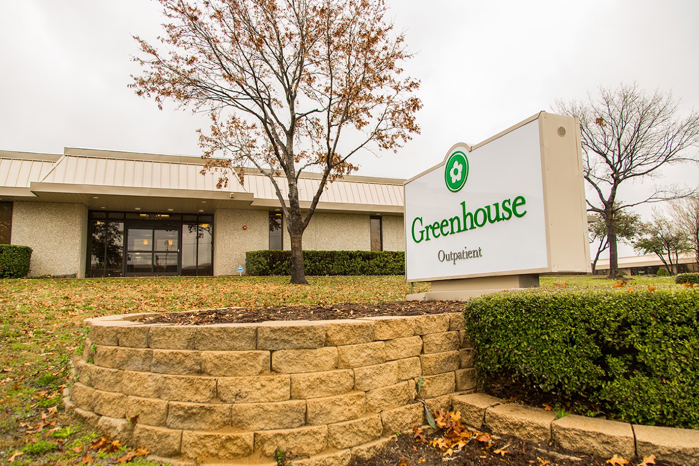  Exterior of Greenhouse Outpatient Center with signage and landscaped entrance