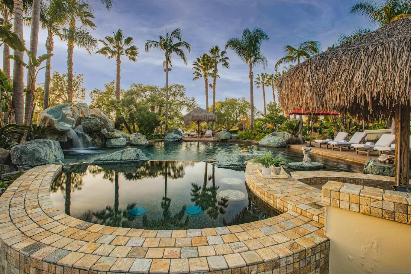 Pool with rock waterfall and shaded seating areas