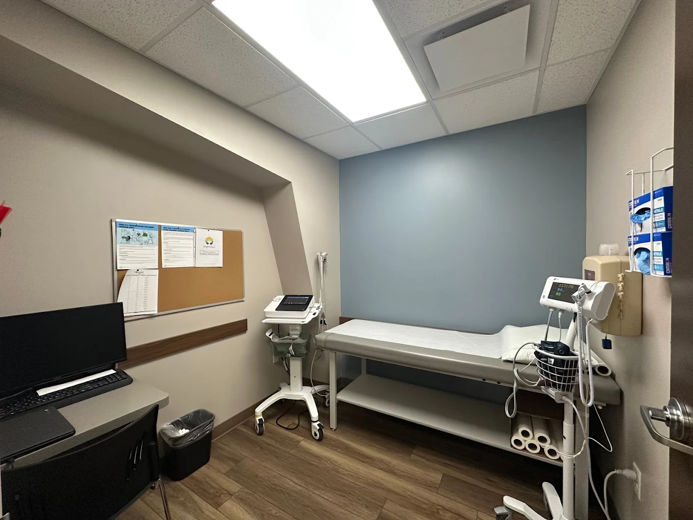 Medical exam room with examination table and monitoring equipment