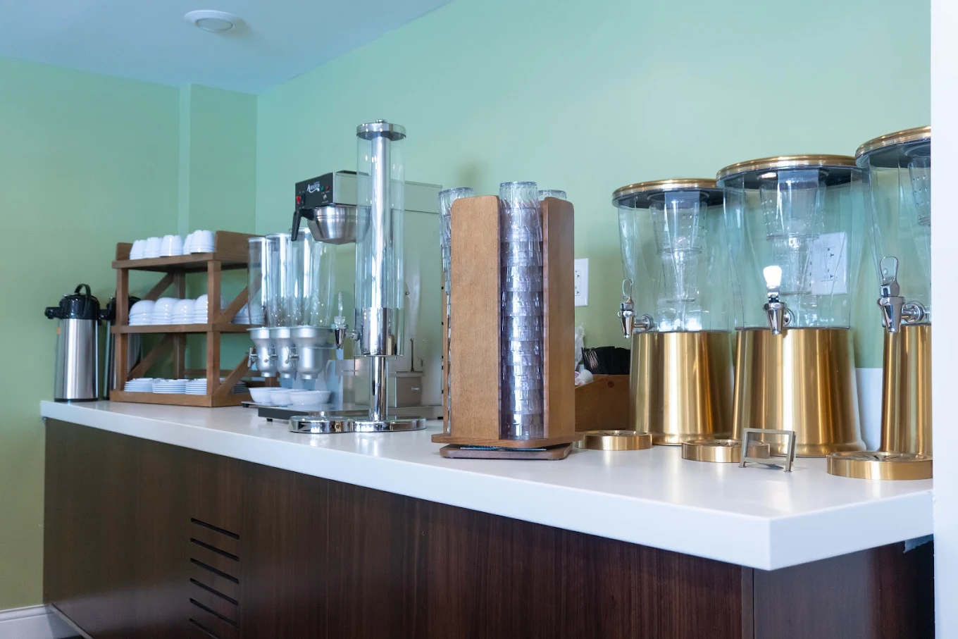 Refreshment station with drink dispensers, cups, and dishes