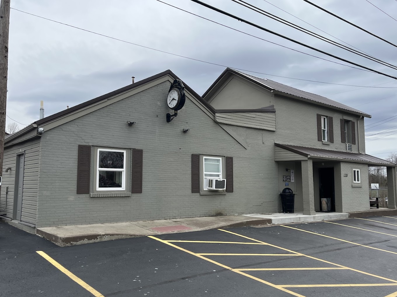 Gray two-story rehab building with parking lot and entrance