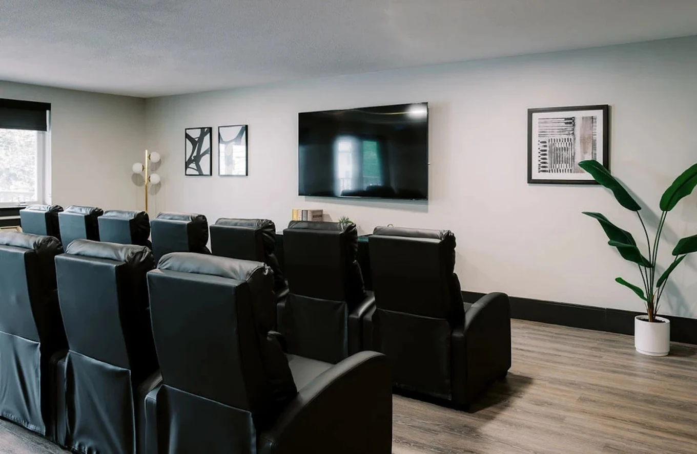 Theater-style media room with recliner seating
