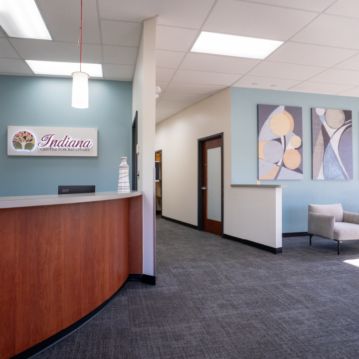 Reception desk and seating area in bright, modern treatment center.